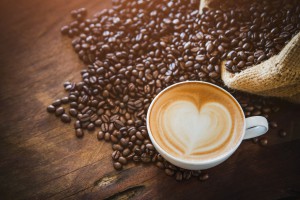 coffee latte with coffee beans  on dark background, top view
